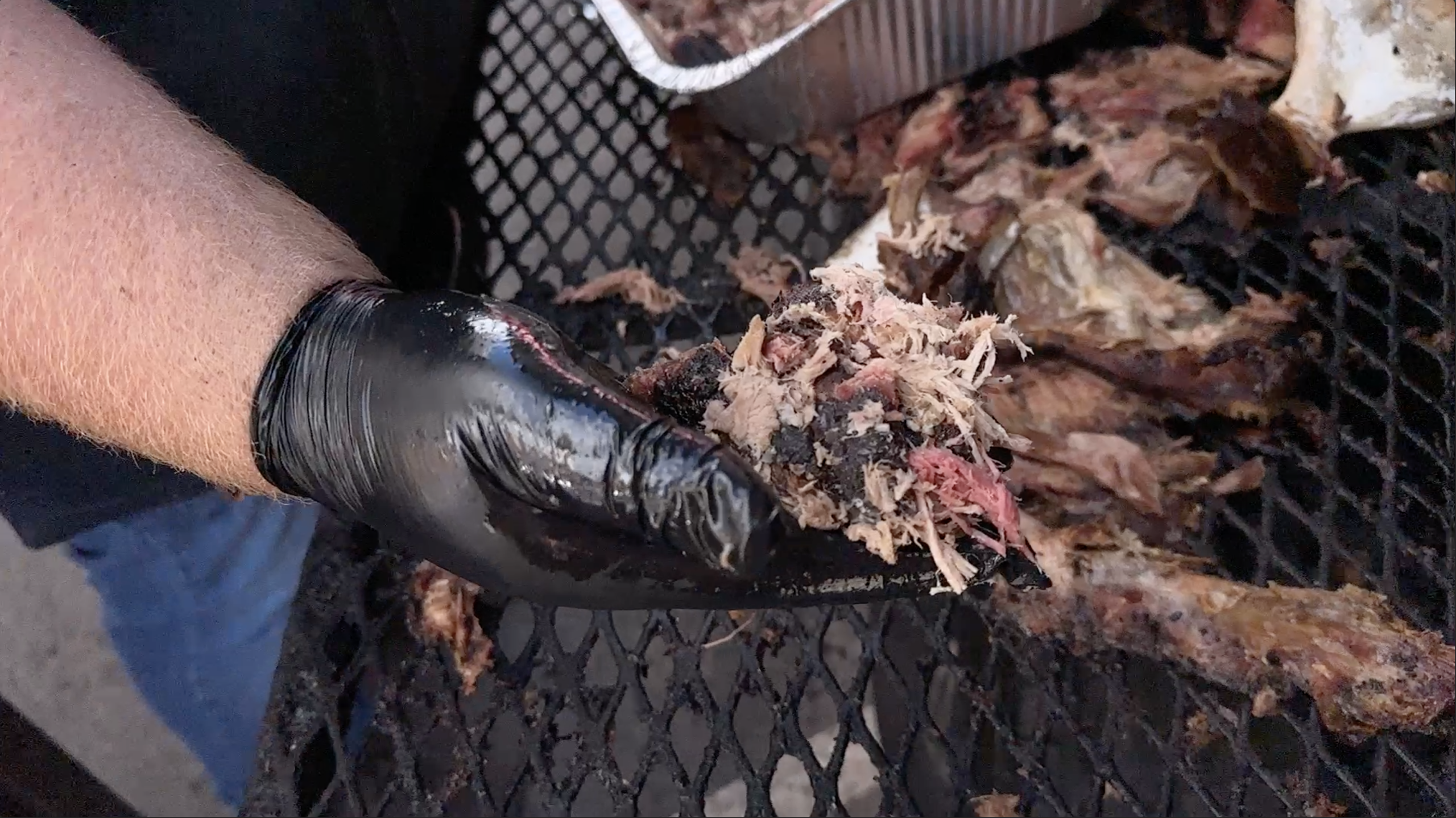 Outstretched hand holding pulled pork Barbecue